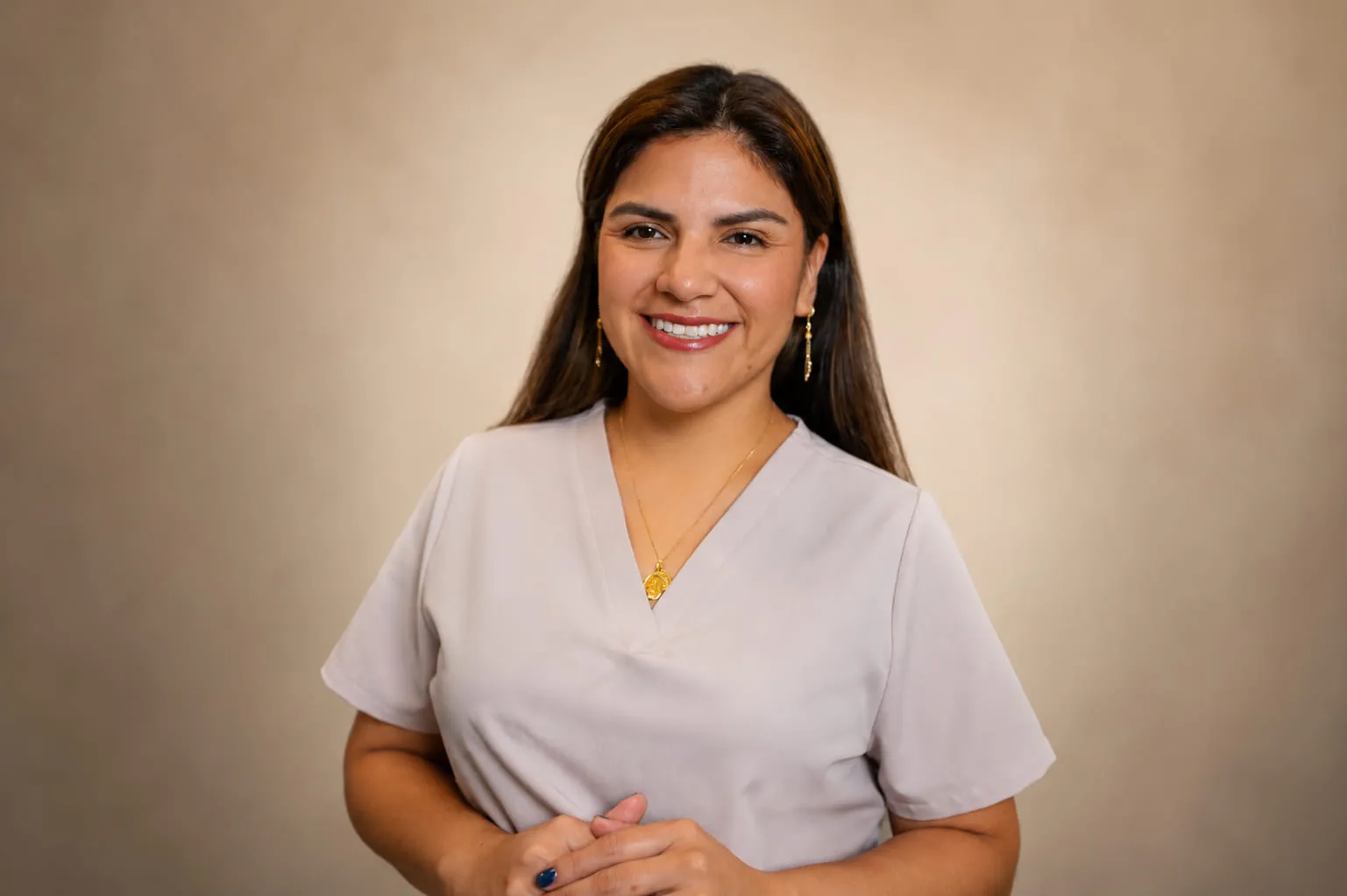 Malu, the certified esthetician behind AGA Beauty, in her studio uniform